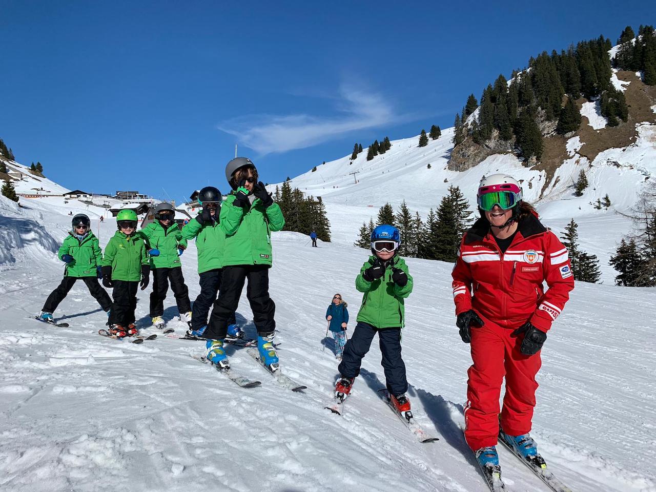 Camp skiers lined up with their instructors before a lesson