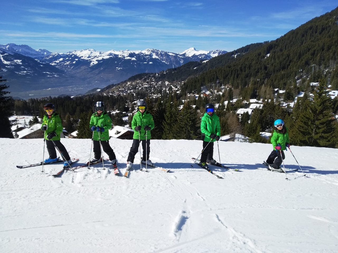 Small ski group on a slope overlooking the Rhone valley