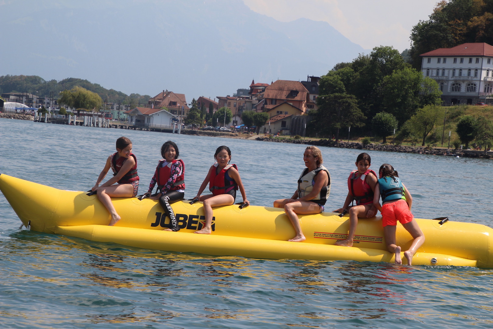 Banana boat ride on Lake Geneva with the shoreline and hills in the background